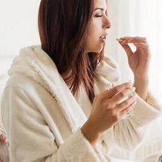 photo-of-woman-holding-glass-of-water-and-pill.jpg