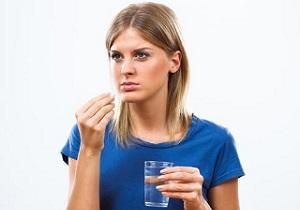 photo-of-a-woman-holding-a-glass-of-water-and-diet-pill.jpg