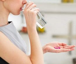 photo-of-woman-holding-glass-of-water-and-pills.jpg