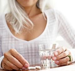 photo-of-a-woman-holding-glass-of-water-and-supplements.jpg