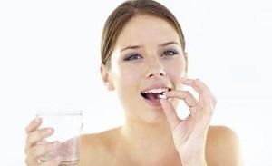 woman-holding-pill-and-glass-of-water.jpg