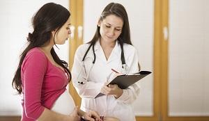 photo-of-pregnant-lady-consulting-doctor.jpg