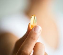 woman-holding-fish-oil-supplement.jpg