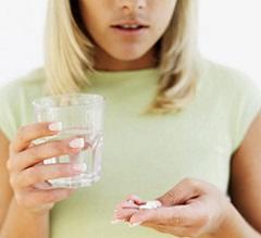 woman-holding-glass-of-water-and-pills.jpeg