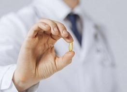 photo-of-doctor-holding-pill.jpg