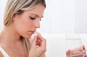 woman-holding-glass-of-water-and-pill.jpg