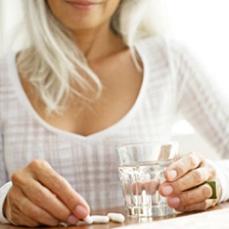 woman-holding-a-glass-of-water-and-supplement.jpg