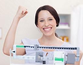 photo-of-happy-woman-on-weighing-scale.jpg