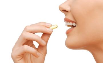 Woman Holding CLA Supplement