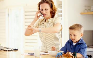 mother-talking-to-phone-with-child-on-her-side.jpg