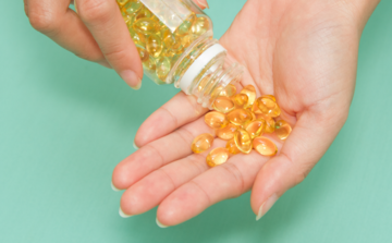 Hand Full of Omega-3 Fish Oil Supplements