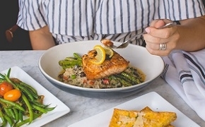 person eating fish meat