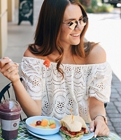 woman eating fruits and sandwich