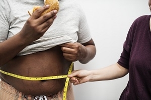 person measuring someone waist line