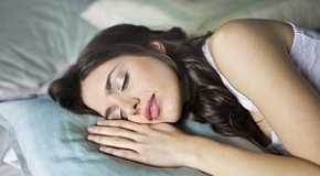 woman sleeping on blue throw pillow