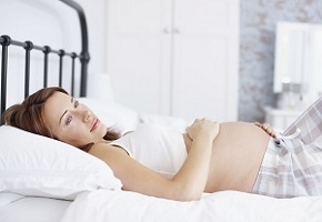 Pregnant Woman with Anxiety Lying on Bed