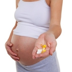 Pregnant Woman Holding Supplements