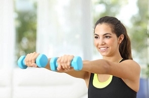 a woman doing dumbbell exercises at the gym