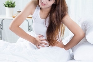 Photo of Woman in Pain Holding Stomach