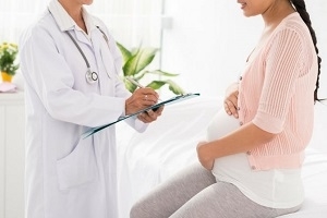Pregnant Woman Consulting Doctor